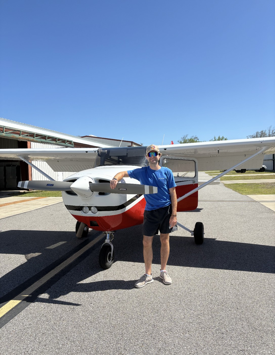 Standing beside a Cessna trainer