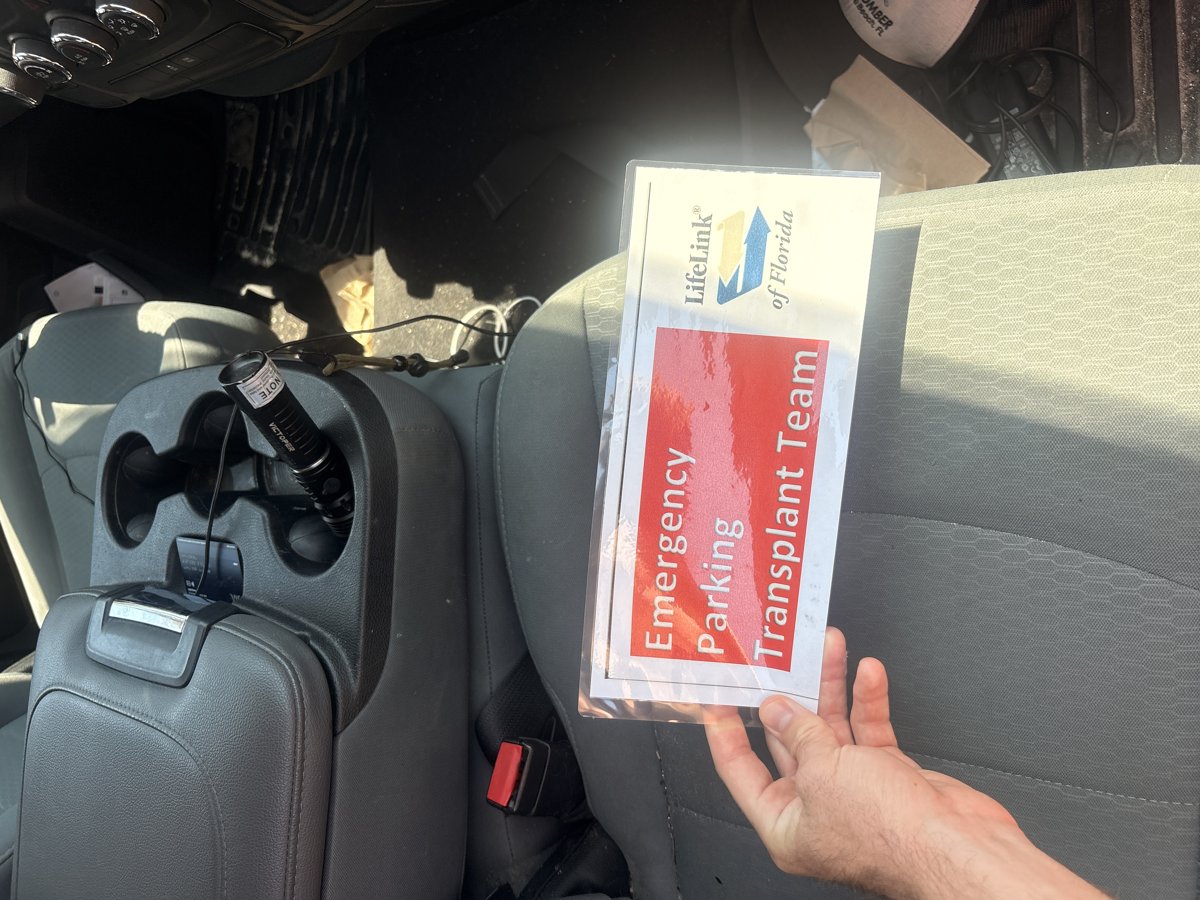 Emergency parking placard for the transplant team, on the dashboard of a response vehicle